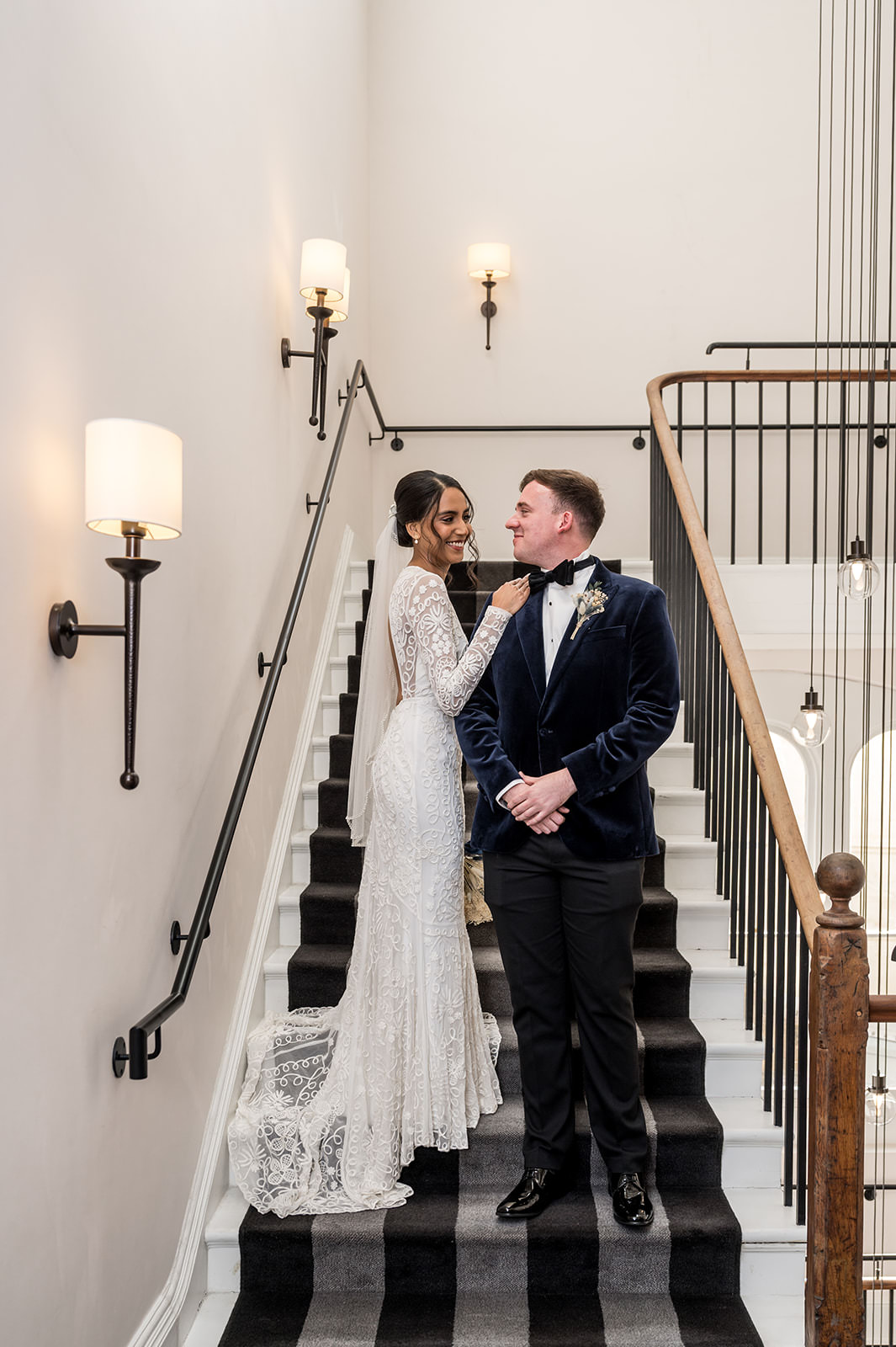 Bride and groom standing on the staircase in the Gainsborough hotel in Bath