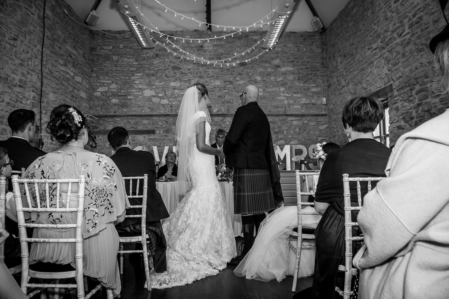 bride and groom exchanging wedding rings at folly farm