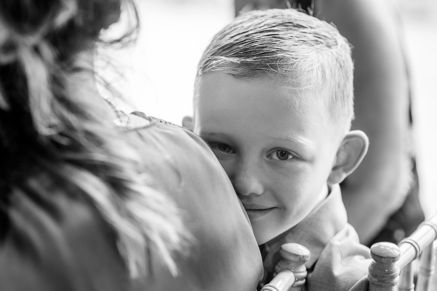 boy smiling during wedding ceremony at folly farm centre