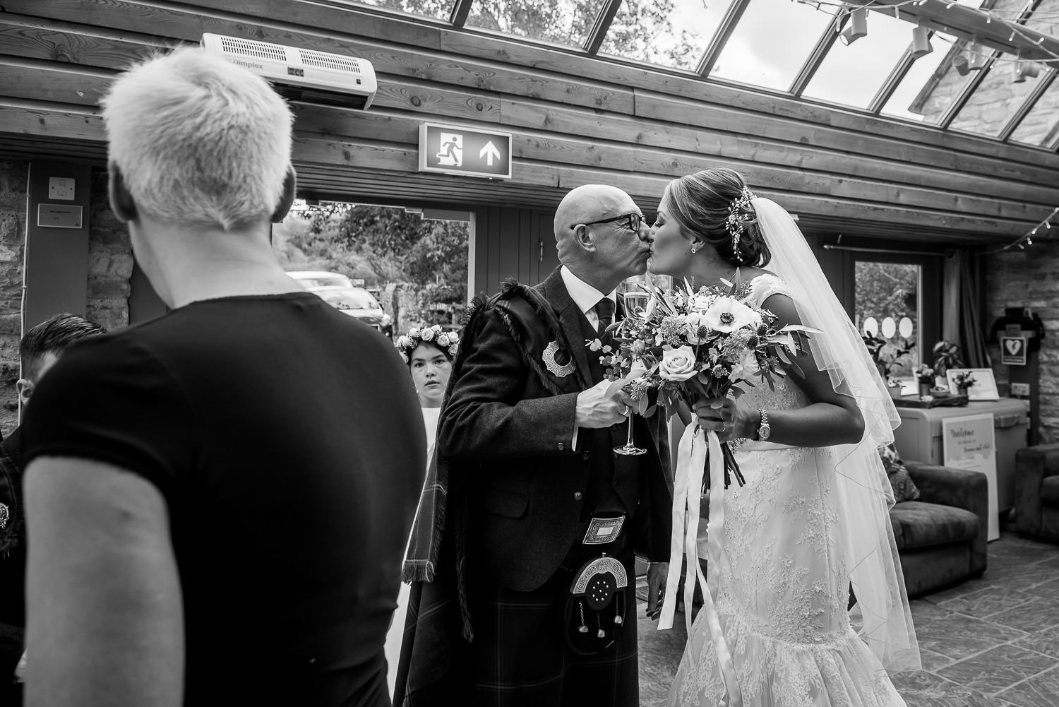 bride and groom kissing at folly farm centre wedding reception