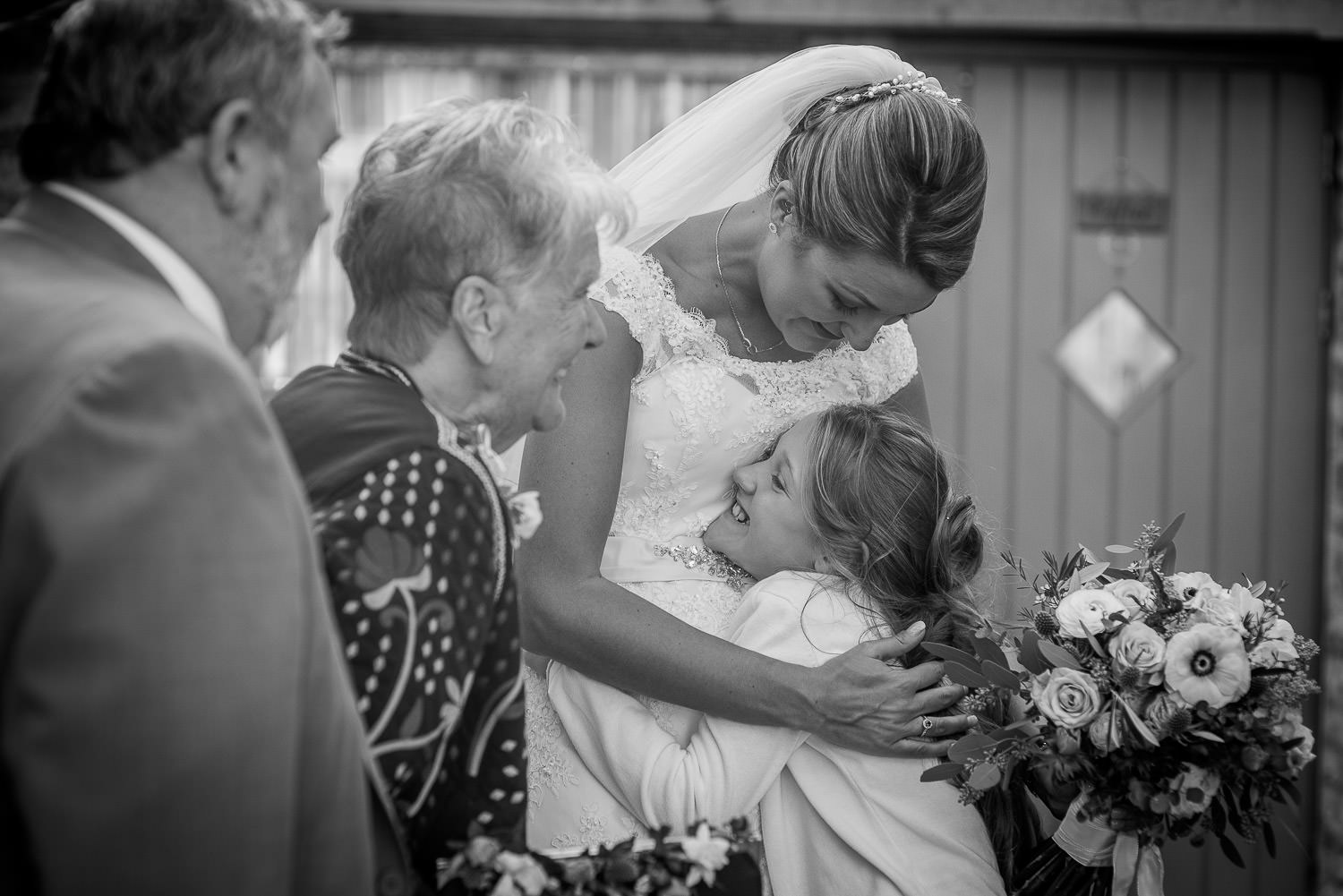 bride hugging a little girl at the wedding reception