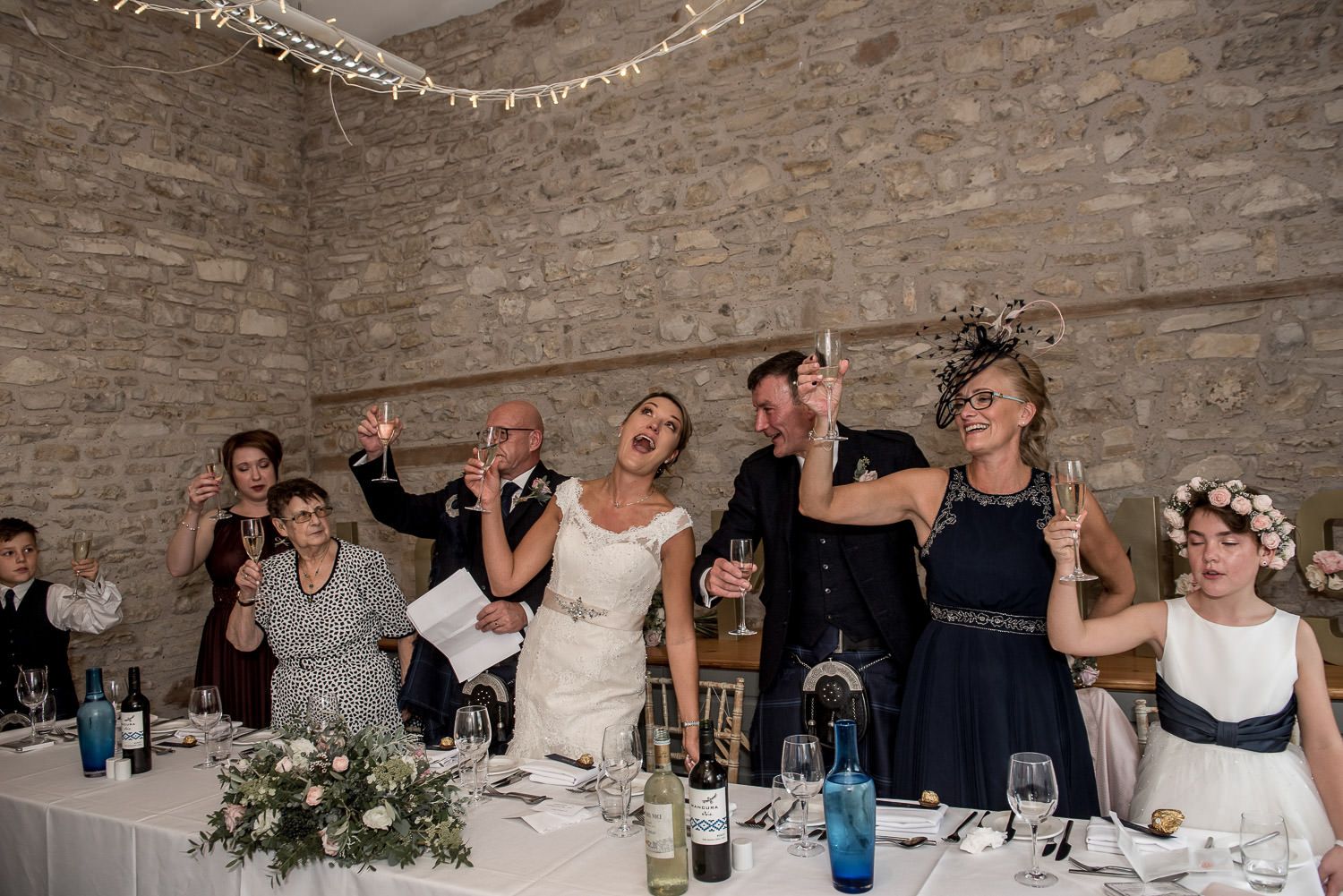 bride groom and guest raising a glass during wedding reception