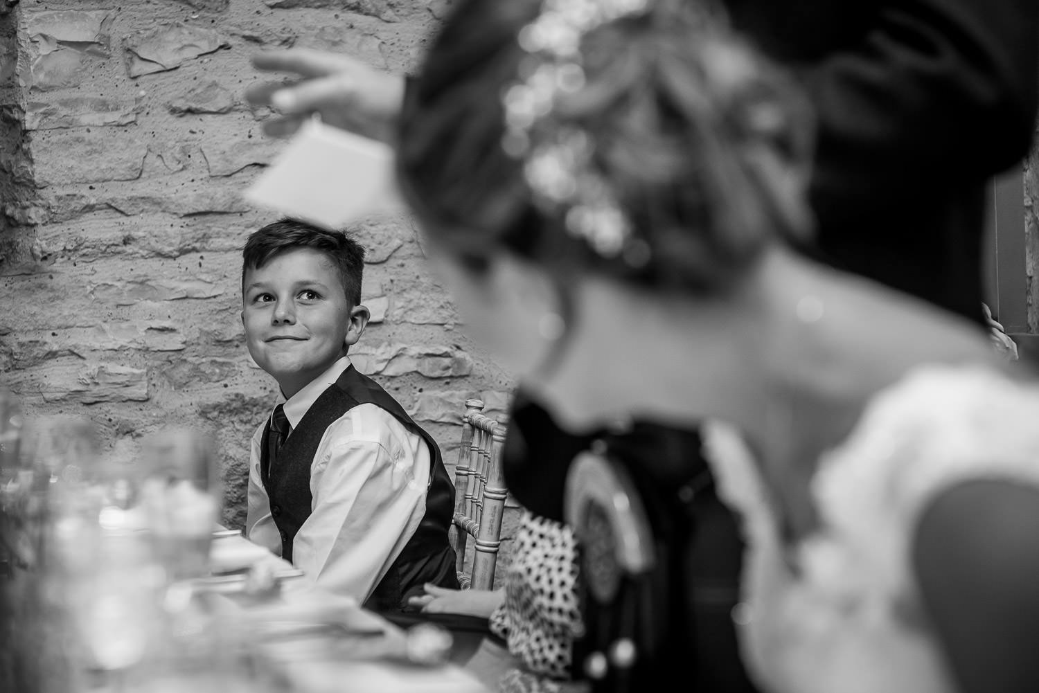 bride looking at her happy son during the groom's speech