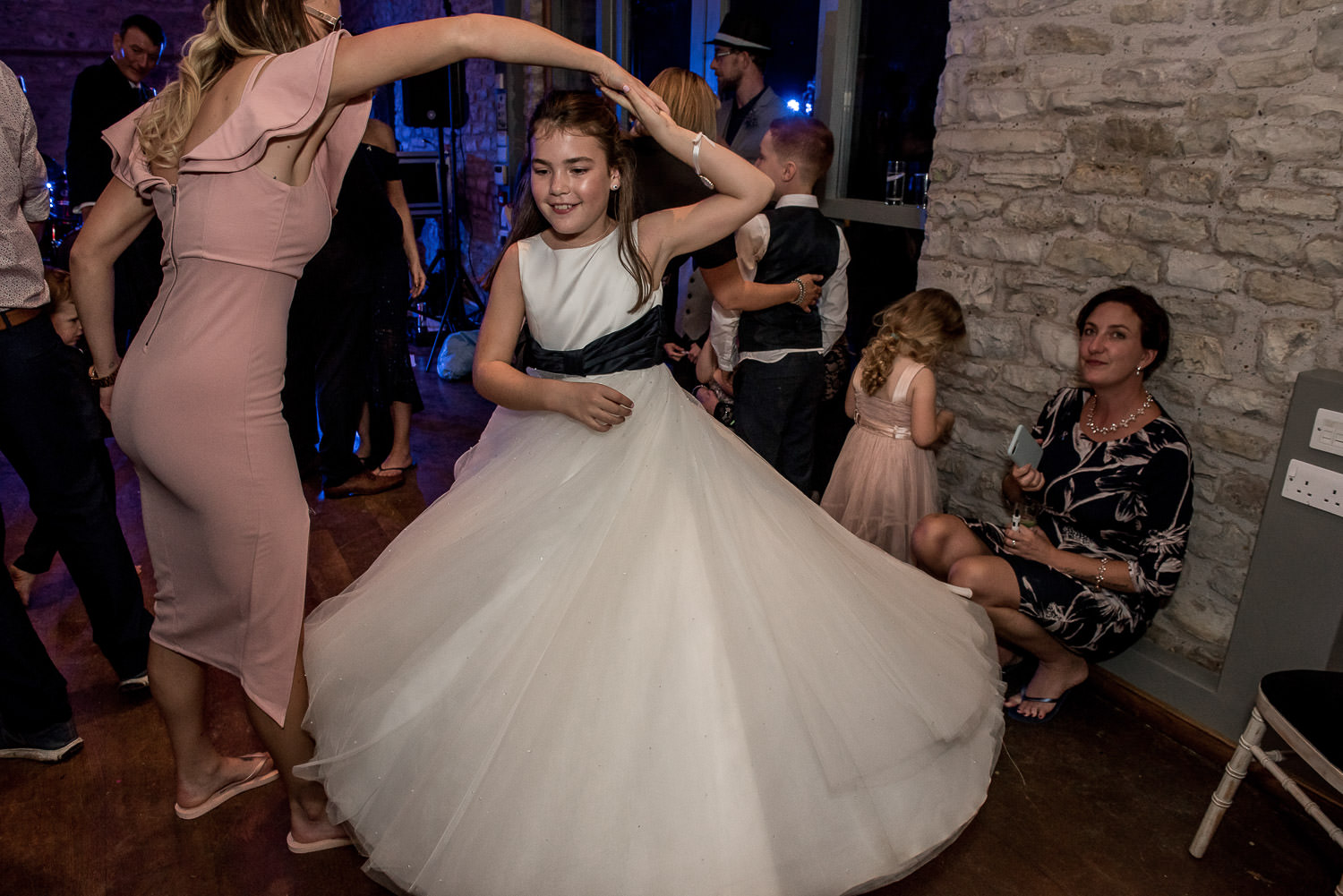 flower girl swirling her dress on the dance floor