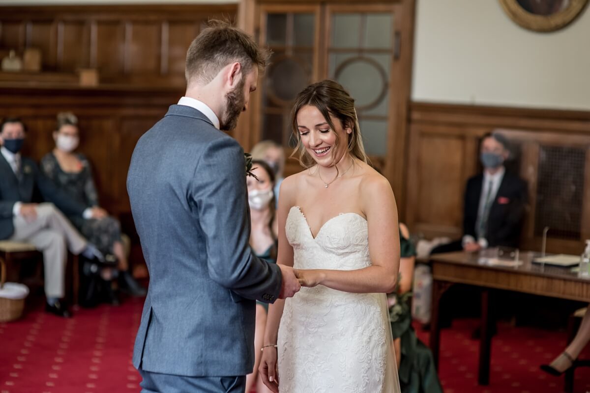 bride and groom exchanging rings, guildhall bath wedding photographer