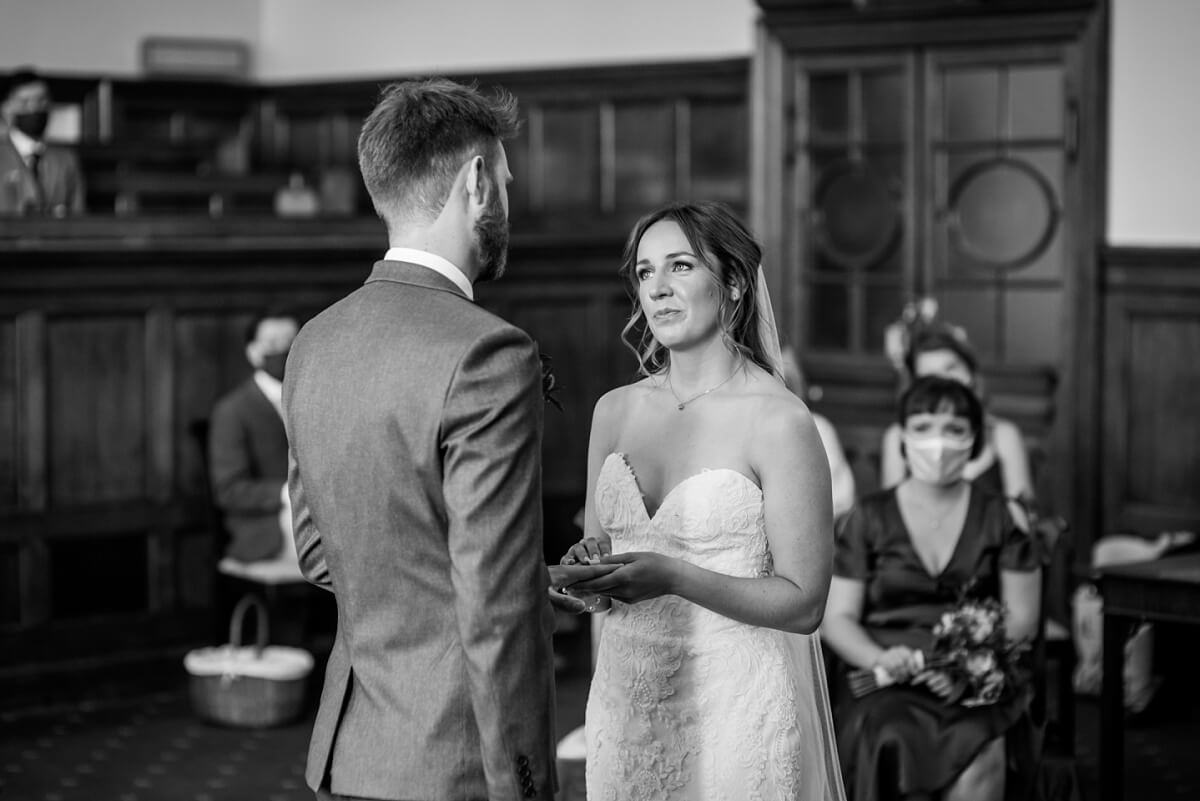 bride and groom exchanging rings, guildhall bath wedding photographer