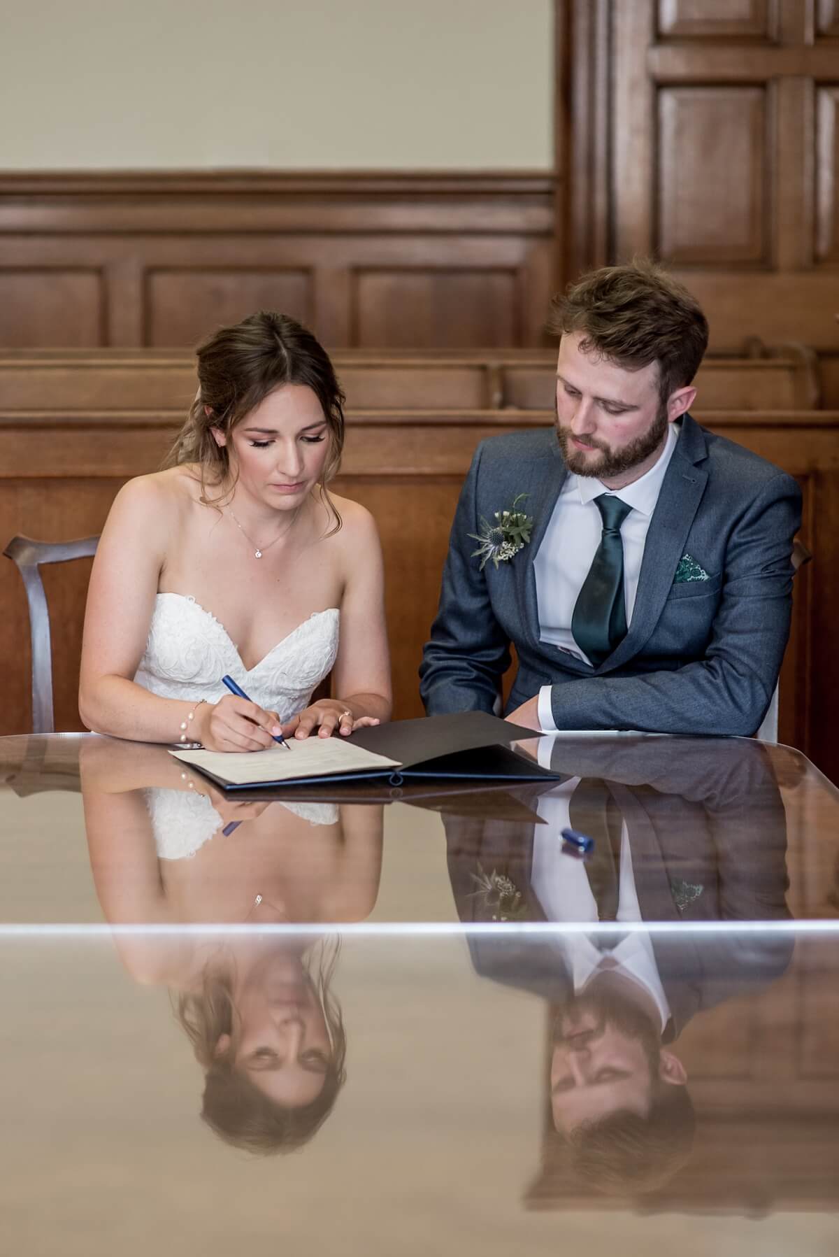 bride and groom signing register, guildhall bath wedding photographer