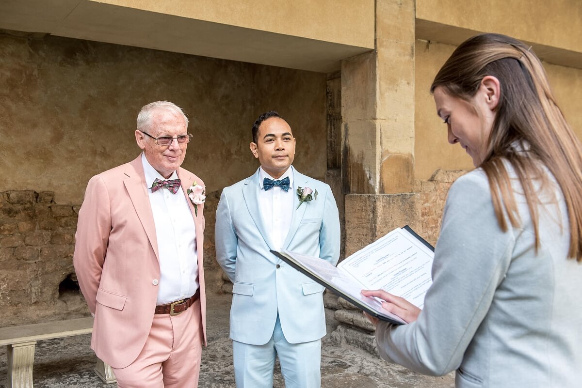 groom and groom at the roman baths wedding in bath