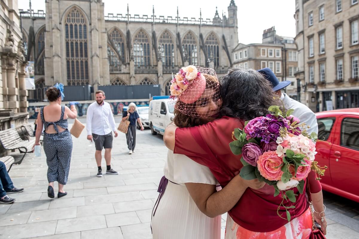 bride hugging her mum outside the guildhall Bath