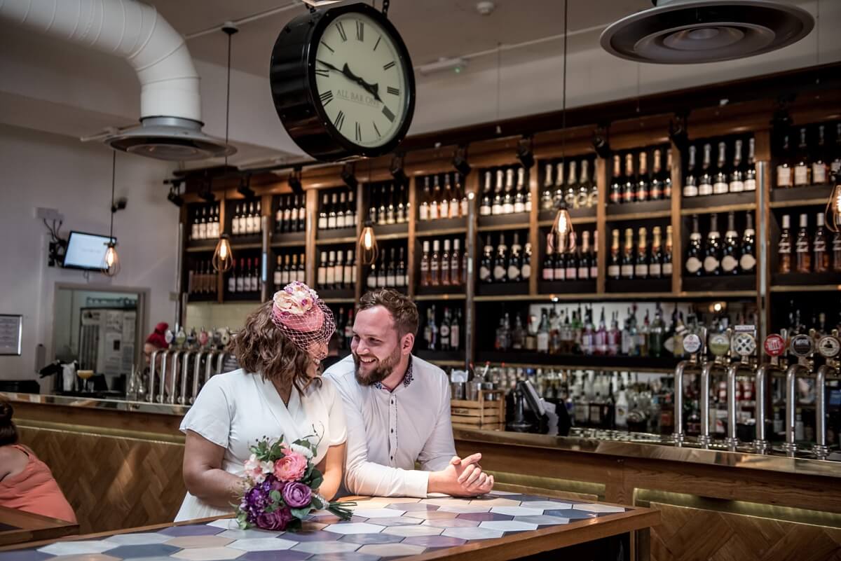 bride and groom having a drink after their wedding